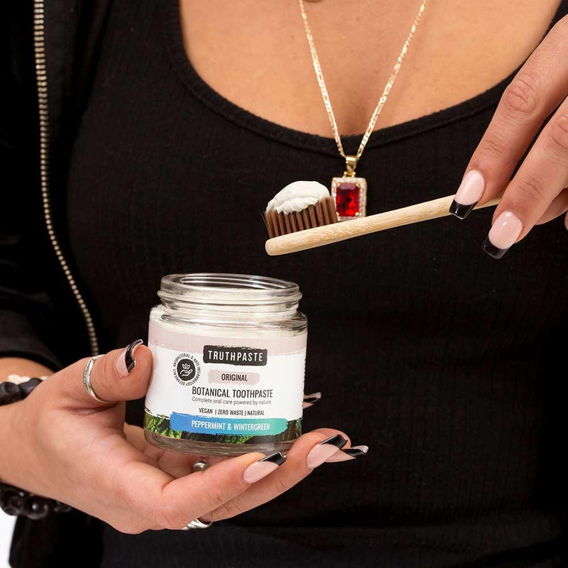 women using botanical toothpaste peppermint and wintergreen