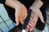 water filter made from natural charcoal in womans hands