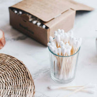 biodegradable cotton buds in a small glass
