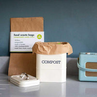 compostable food waste bags next to bin