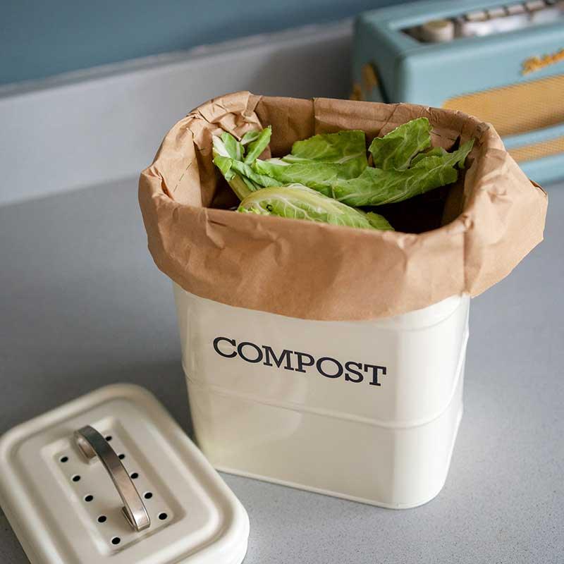 compostable food waste bag inside a small compost bin