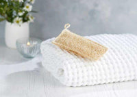 kitchen and bathroom scrubbing loofah on a towel
