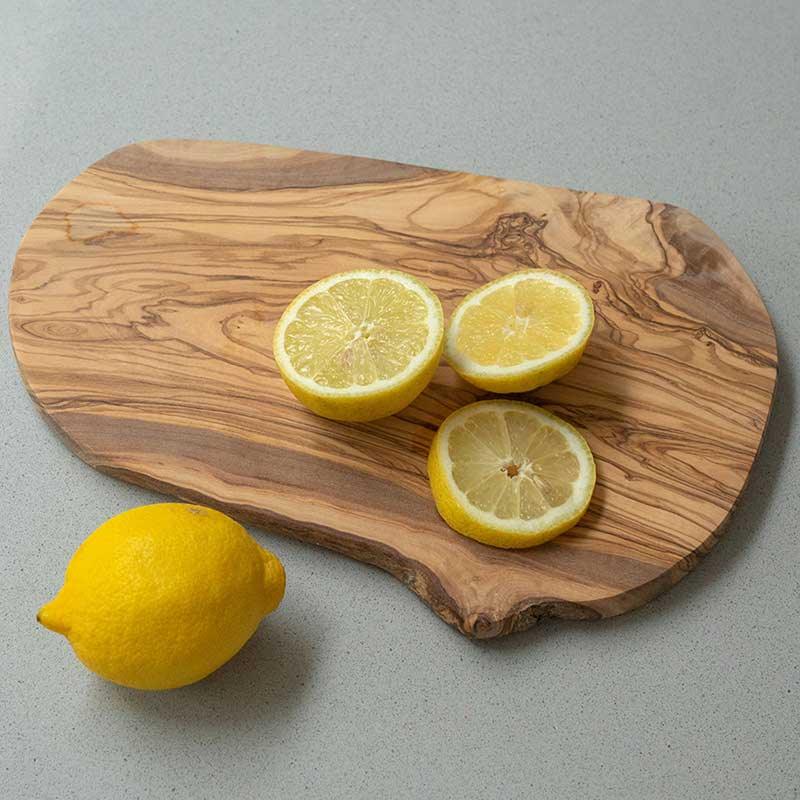 sliced lemons on an olive wood chopping board
