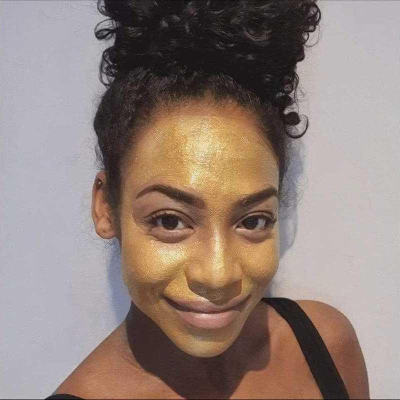 woman using evolve bio retinol gold face mask