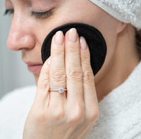woman using reusable facial wipes
