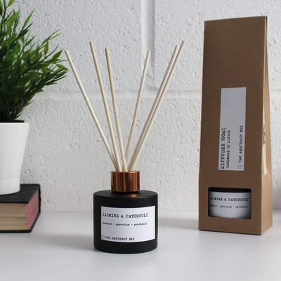 jasmine and patchouli reed diffuser next to packaging
