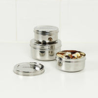 stainless steel food containers arranged on a table