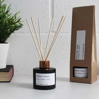 reed diffuser next to cardboard packaging