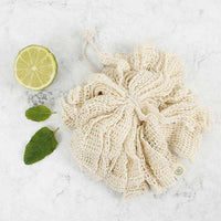 organic cotton body puff next to a lime