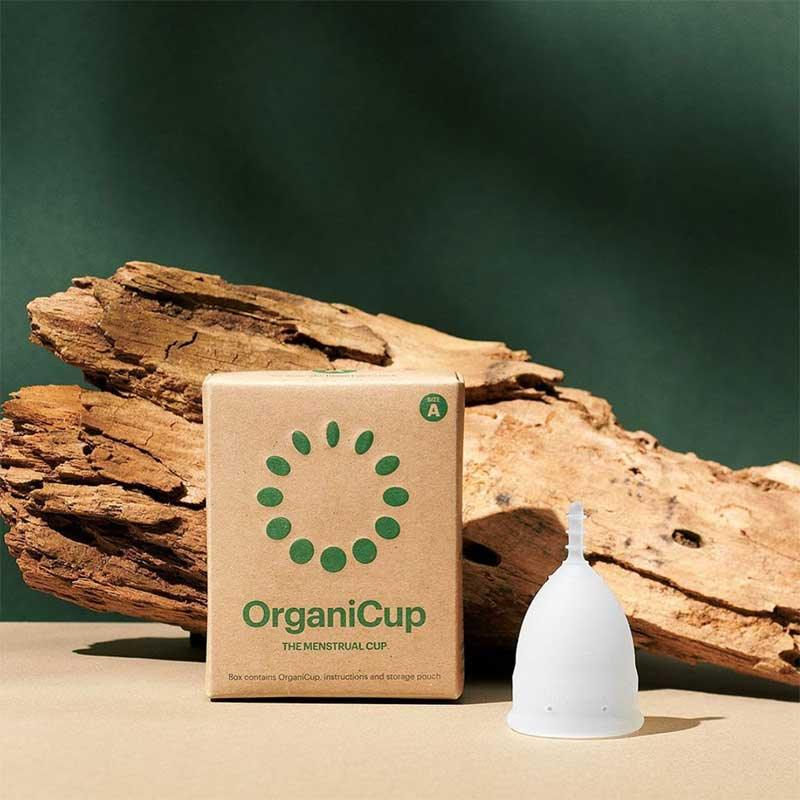 organicup menstrual cup next to a log