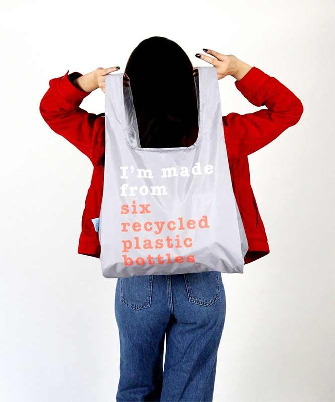woman holding recycle print shopping bag