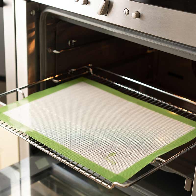 reusable baking sheet on a tray in the oven