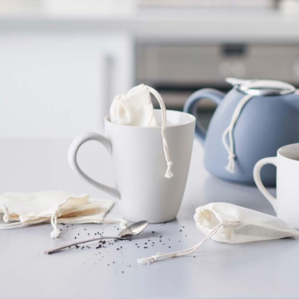 reusable tea bags on a kitchen side next to teapot