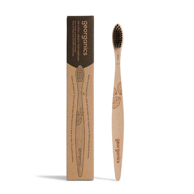 wooden toothbrush next to cardboard box