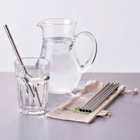 stainless steel drinking straws next to jug of water
