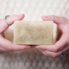 woman holding natural bar of soap with hands