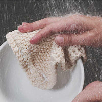 cleaning a dirty bowl with a sustainable dish scrubber